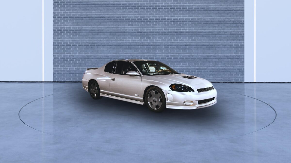 The prepared photo of the same silver coupe on a plain studio backdrop